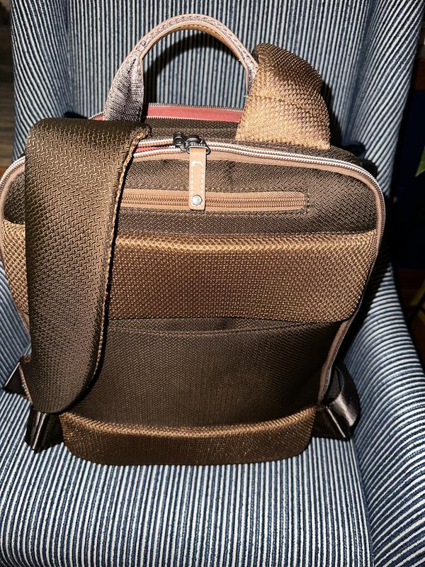 Additional zip pocket at top for laptop charger. Correction: There ARE slits for sliding onto carry on handle.