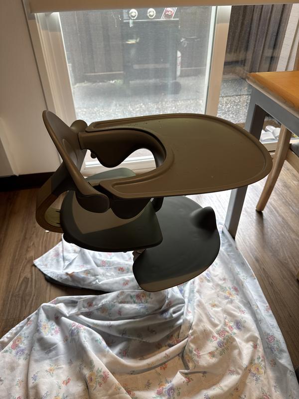 A great place to store the tray when not in use is to lay it on the foot rest, and slide the high chair back up close to the table. We have a tiny apartment and this saves us space!
