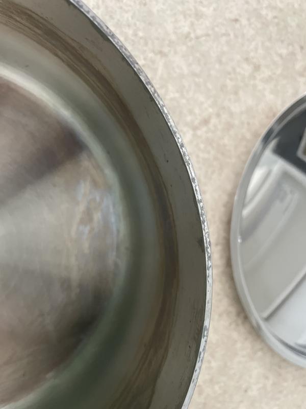 Rough/unfinished edge of pan.