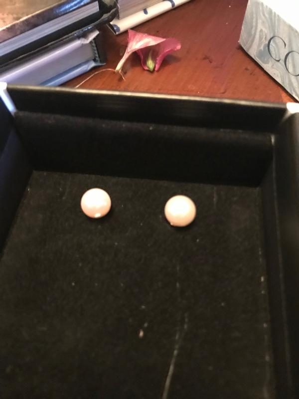 left one has a white flaw on it.  The pic makes them both look pink but the right one is more white than pink.