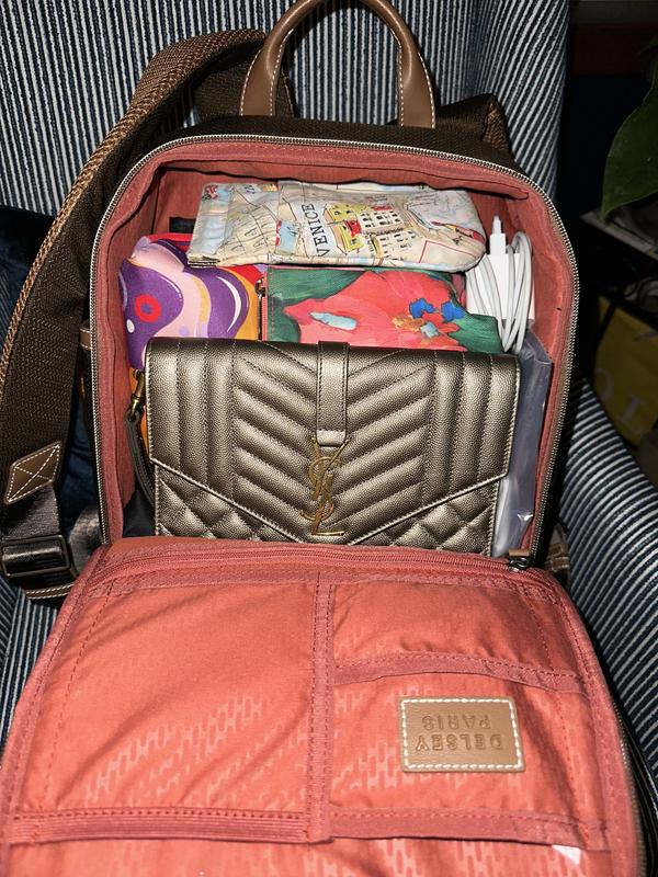 Front zips down 3/4 for easy opening & packing. Lots of pockets & includes toiletry bag.