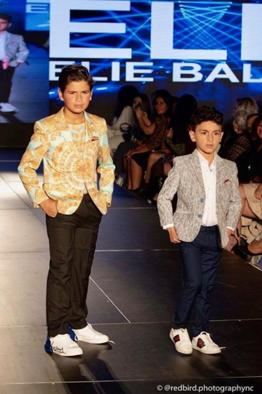 my son on the runway first day of fashion week he is on the left in the mint green and gold