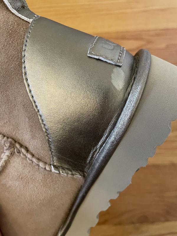 See the white lighter area where the metallic is missing? Plus seam of fabric at bottom is all bunched. Poorly made.