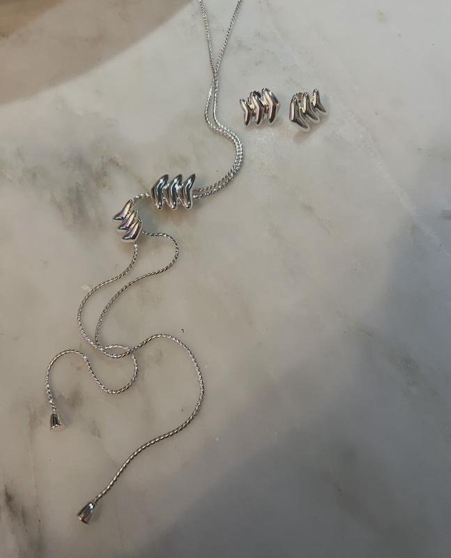 It comes with matching earrings, which I bought from their website