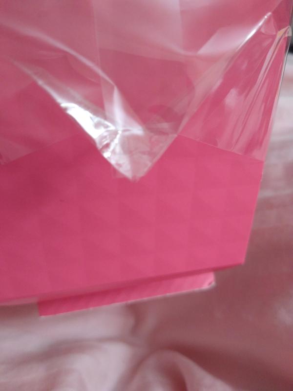 Small piece of clear tape used to reseal this corner of cellophane.