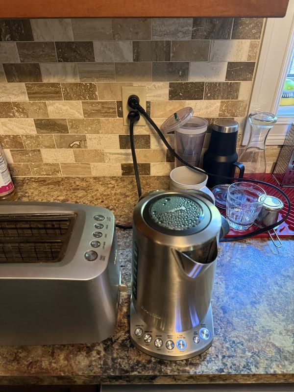Shows how the IQ Kettle cord is in the way of other things on the counter while the toaster cord hangles down the wall nicely.