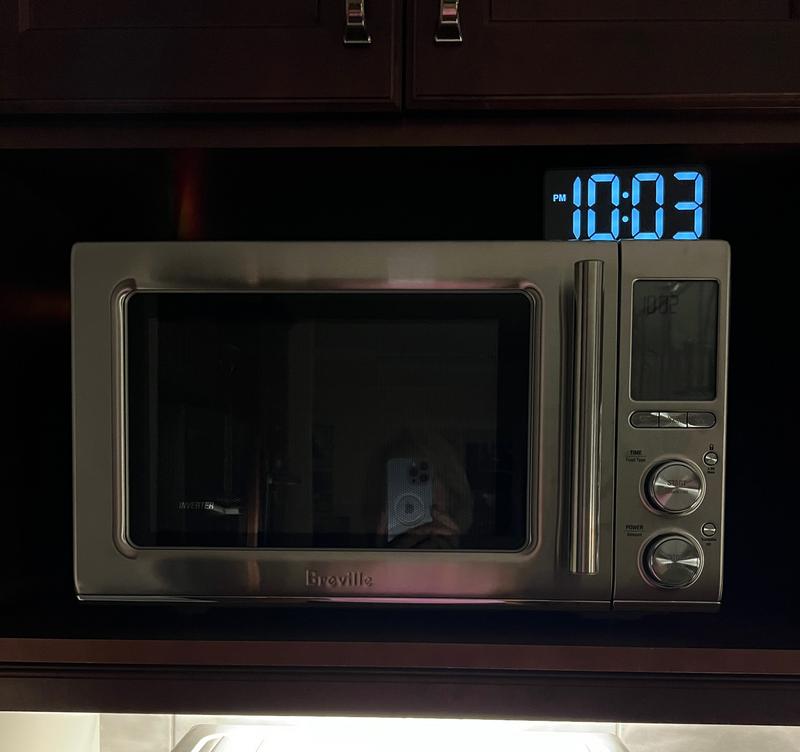 Microwave in dimly lit kitchen