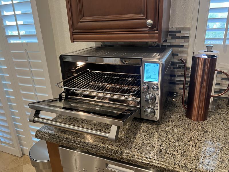 Magnets on door help pull out middle-position shelf