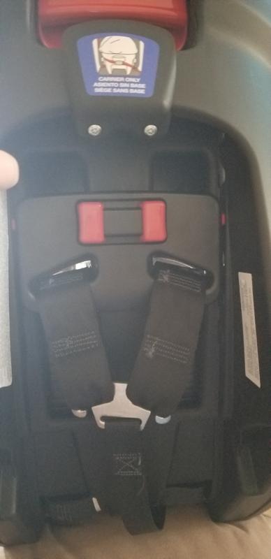 Press in the red buttons to adjust harness height