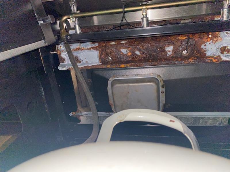 Underneath grill. Ignitors are barely holding on due to rust on the bottom plate
