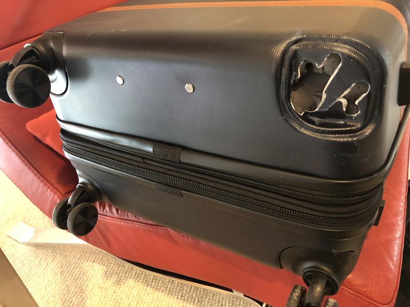 Wheel torn off during baggage handling.