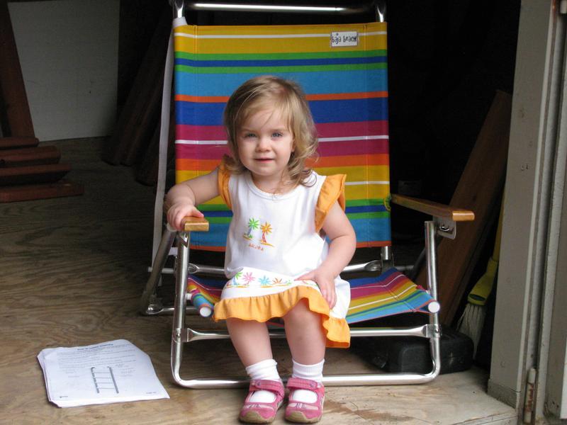 One of the Grandkids helping Grandpa assemble her swing set. See directions on floor