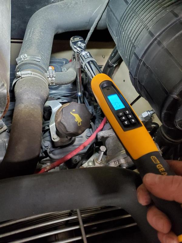 Checking the torque of the valve cover bolt on a military Case skid steer.