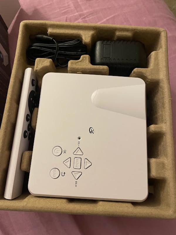 Projector unwrapped in cardboard holder