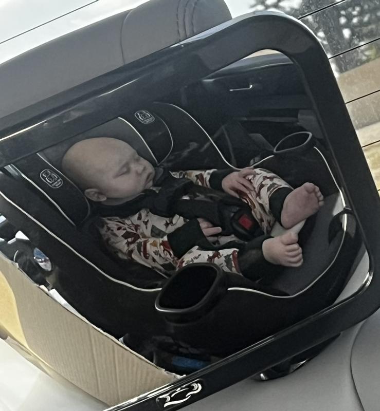 In the baby mirror. He is so comfy and sleeping soundly. Perfect fit.