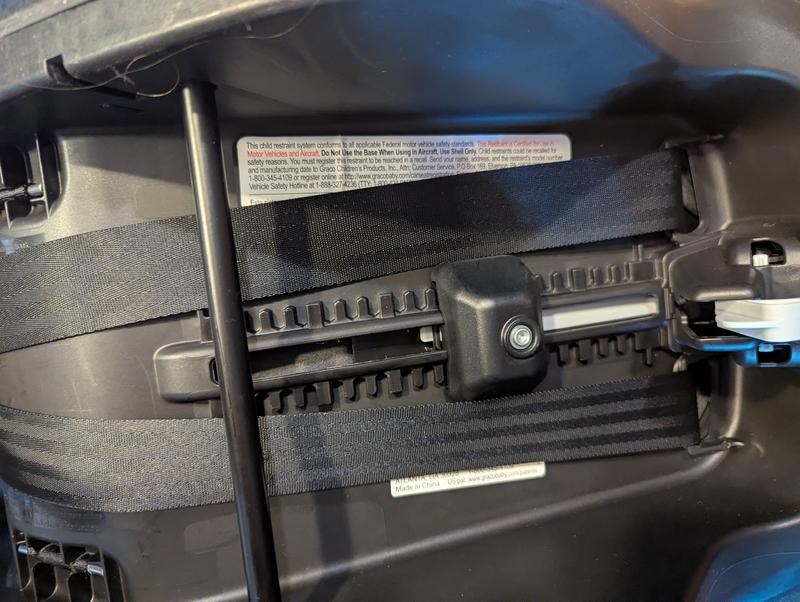 Terrible location of aircraft approval sticker on BOTTOM of car seat!
