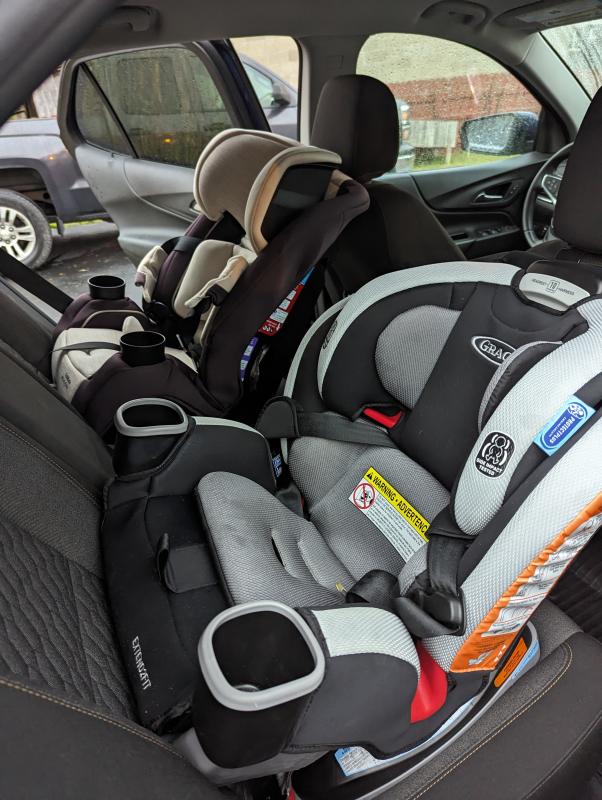 View of seat installation, rear facing with seatbelt| Another view of the car seat| View of opposite side with a second car seat installed