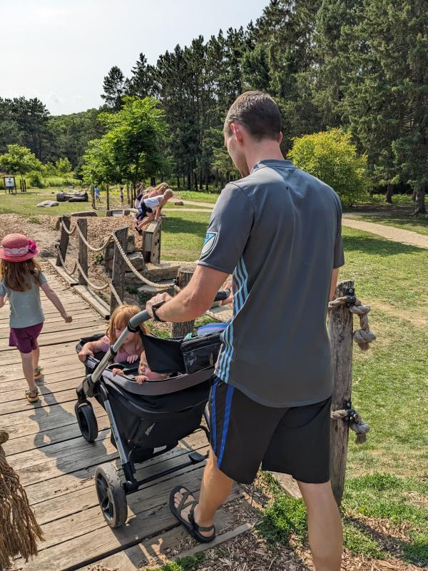 Testing out the uphill capabilities.| Folds easy and compact.| Box description- Footwell "zips out for easy cleaning or for optimal storage." No instructions in the manual.| Wheels for all-terrian.| Nature park outing.| Caught in the rain-towel covering the gap.| Still dry!| Splash pad with my 5 & 3 year olds.| Loaded up for the pool!| Caught in the rain- notice the gap between the canopies.| Pushing the girls at a nature park.