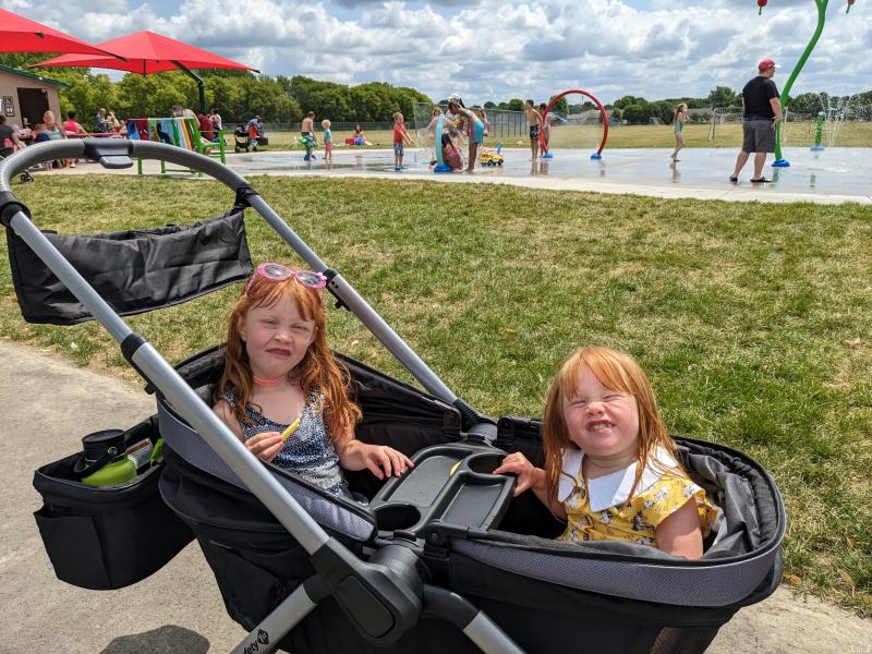 Testing out the uphill capabilities.| Folds easy and compact.| Box description- Footwell "zips out for easy cleaning or for optimal storage." No instructions in the manual.| Wheels for all-terrian.| Nature park outing.| Caught in the rain-towel covering the gap.| Still dry!| Splash pad with my 5 & 3 year olds.| Loaded up for the pool!| Caught in the rain- notice the gap between the canopies.| Pushing the girls at a nature park.