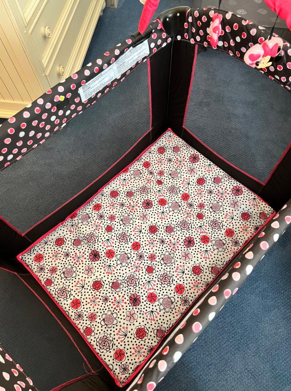 Adorable Minnie Mouse details| Exterior of Play Yard with super cute print and breathable sides| Colorful easy to wipe-down mattress that can be used with or without a sheet.