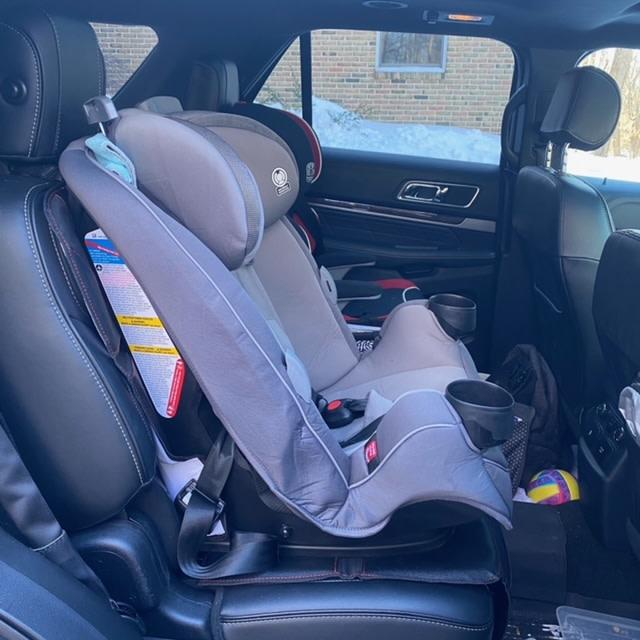 Front of seat, next to high back belt booster seat (red)| Side view, next to high back belt booster seat (red)
