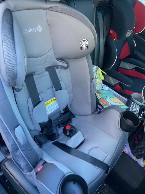 Front of seat, next to high back belt booster seat (red)| Side view, next to high back belt booster seat (red)