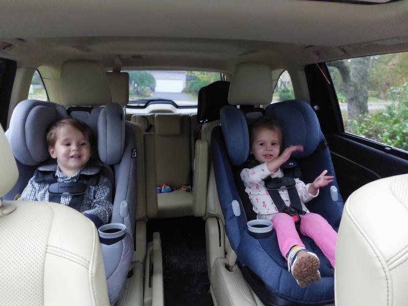 The twins preparing for their first ride in the new car seats.