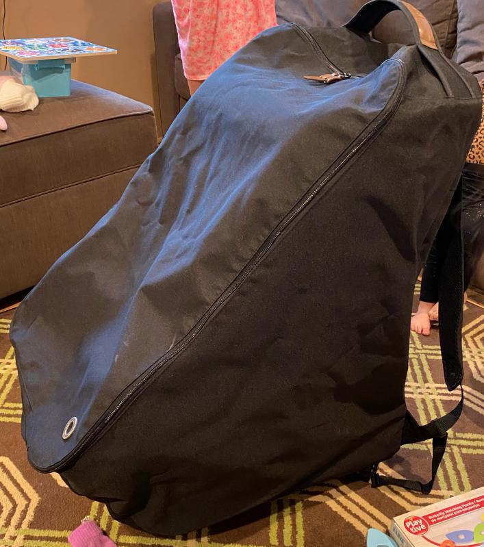 shoulder straps - 1 folded in and 1 out| bag with zipper half open