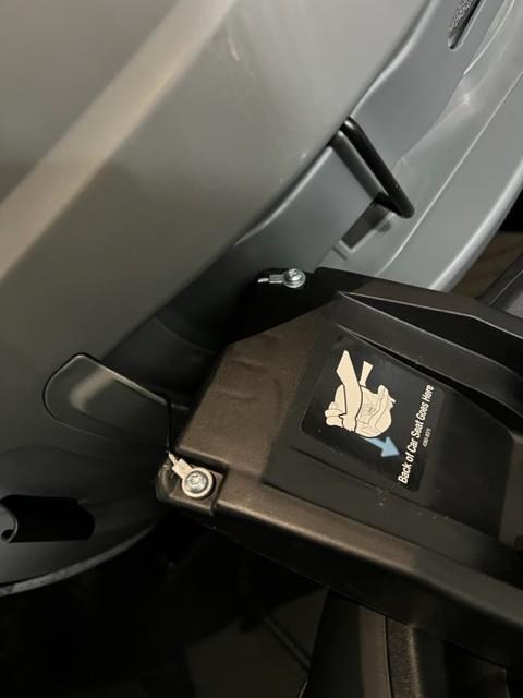 Red to Green indicators to say the seat belt is tight.| Seat hanging between captain's chairs while installing.| Rear Facing| Rotated toward the door.| Wire that connects the seat to the base.