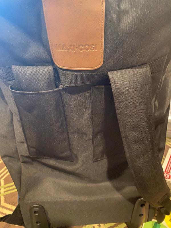 shoulder straps - 1 folded in and 1 out| bag with zipper half open