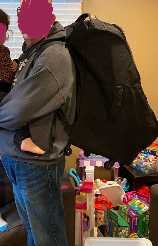 shoulder straps - 1 folded in and 1 out| bag with zipper half open