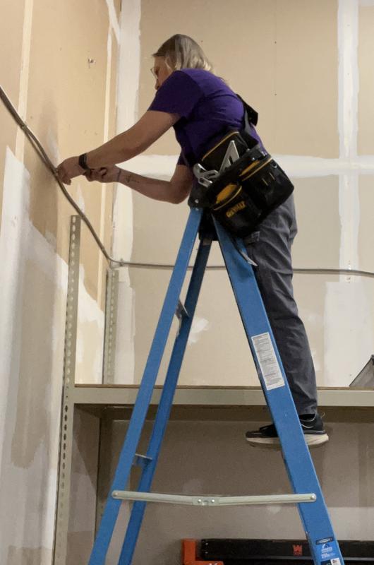 Throwing it over my shoulder, saves my hips when I am climbing ladders.