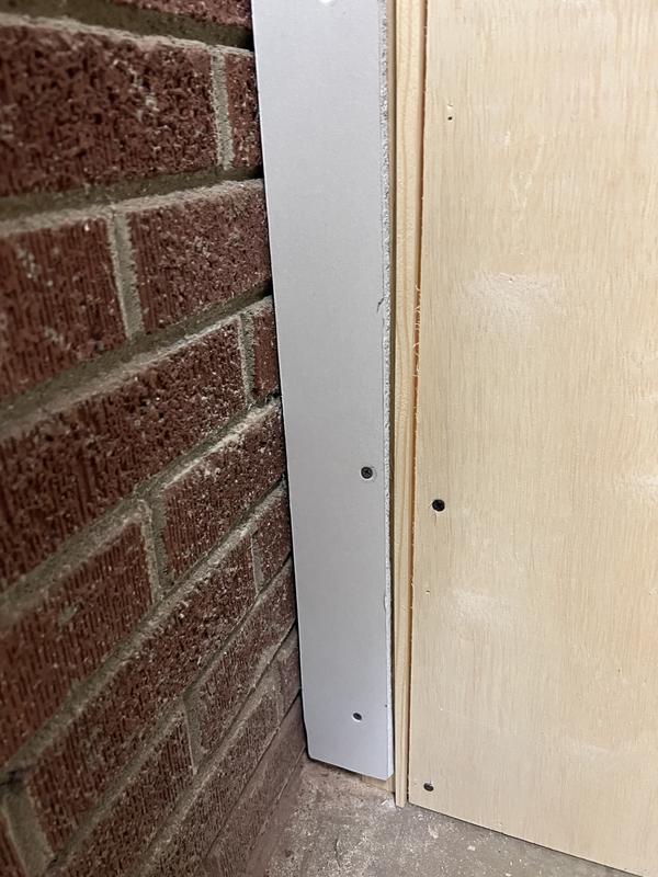 door frame planed to fit out of plumb brick wall
