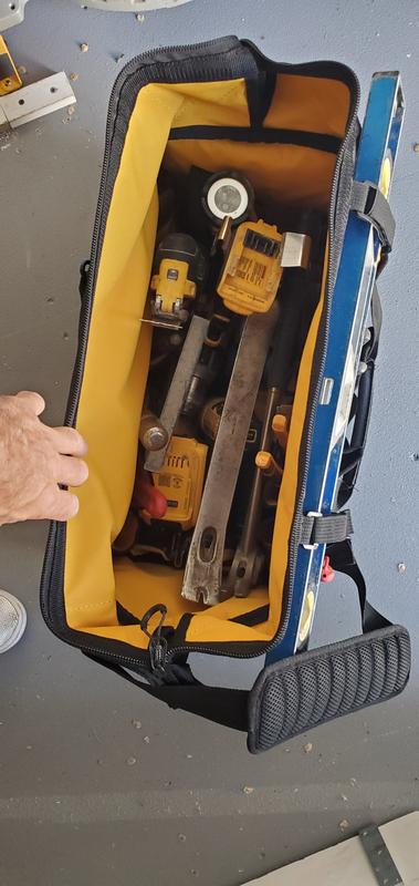 Inside has compact circular saw, impact gun, oscillating tool, drill, hammer, pry bar, speed square, misc hand tools, etc.