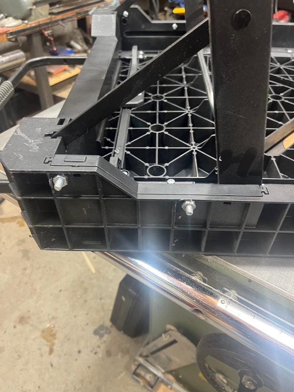 The corner insert with two bolts to hold it in place. The original design just has it slid in place and is a bit wobbly.