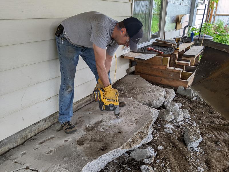 Using the hammer to help me prep a chunk of ancient concrete to break it up.
