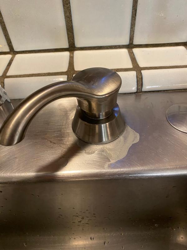 Dispenser with leak around base.