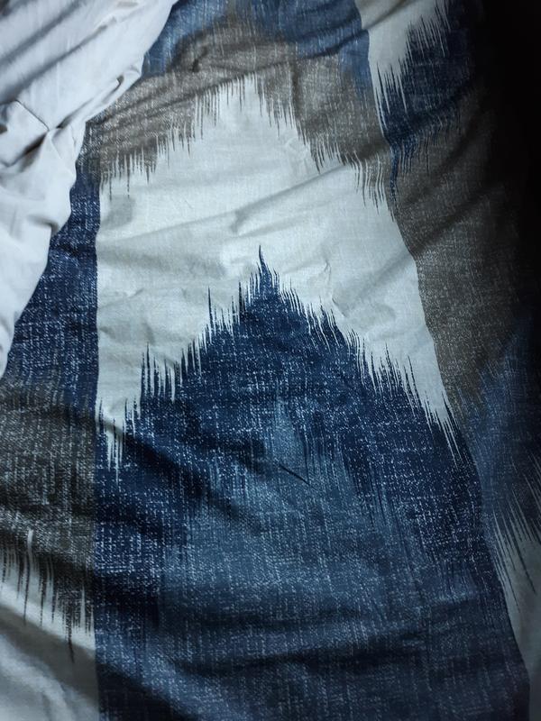 Here is a close up of the Alpine three piece duvet cover mini set full / Queen Navy the broken chevron pattern in navy, Dusty blue, charcoal, and taupe colors on an ivory background and the reverse is a Dusty Navy solid color