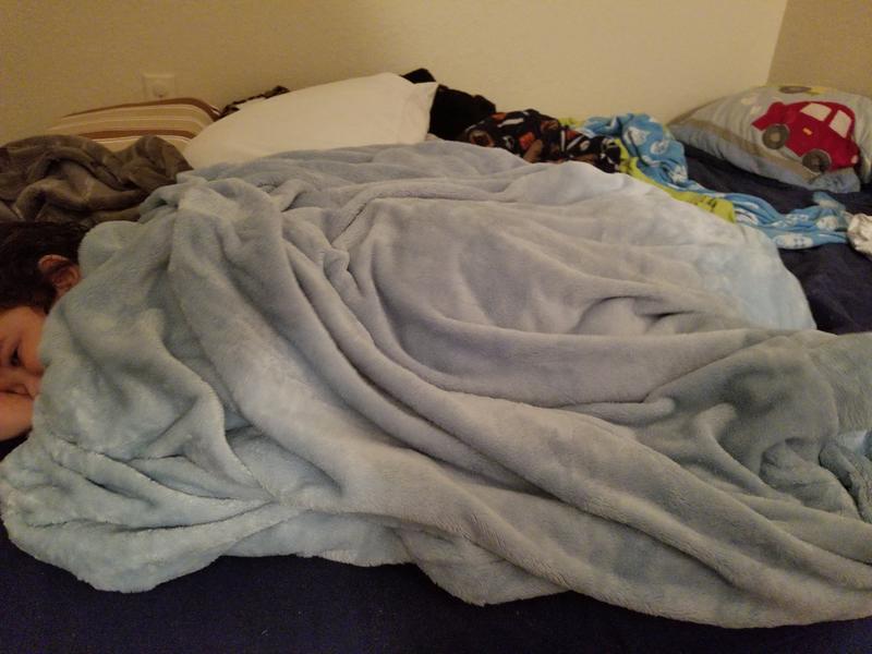 My toddler enjoying the benefit of this amazing weight blanket.