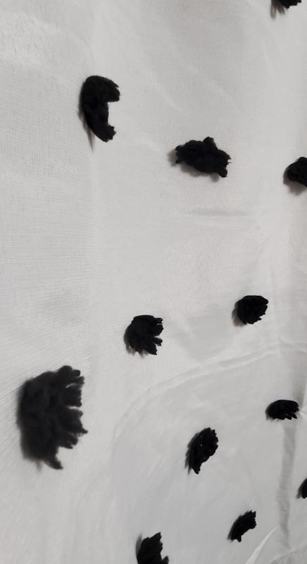 The pom poms on the shower curtain