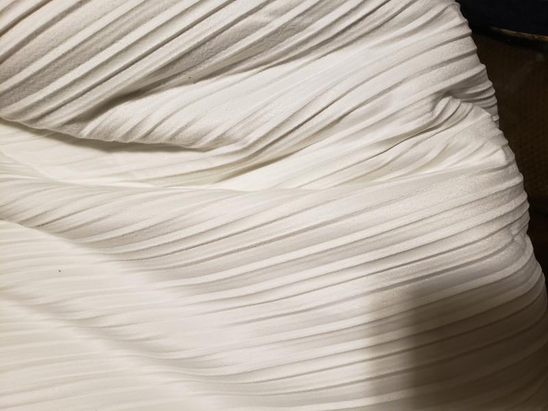 Has a riveted look, but so soft. Looks Ivory but yet with the sunlight can look light gray.