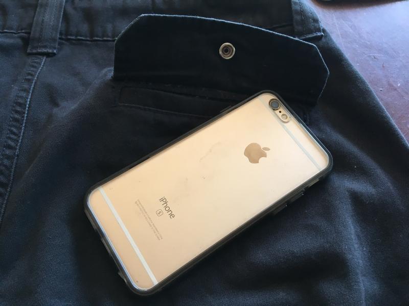 The iphone 6s will fit in the back pocket and close if you place it like this