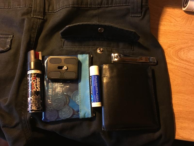 The following can all fit in the back pocket and be securely closed, probbaly not comfortable to sit down on, but my main point is that you can fit a lot just in the back pocket