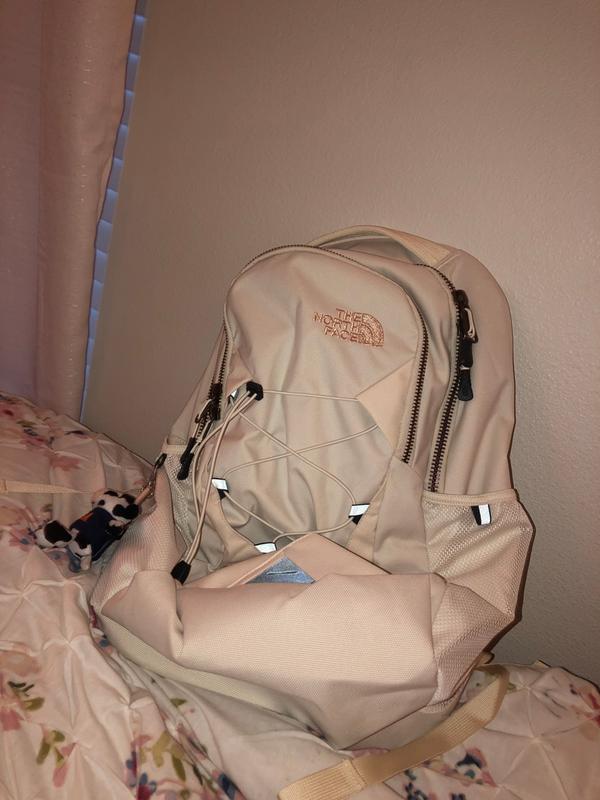 north face white and rose gold backpack