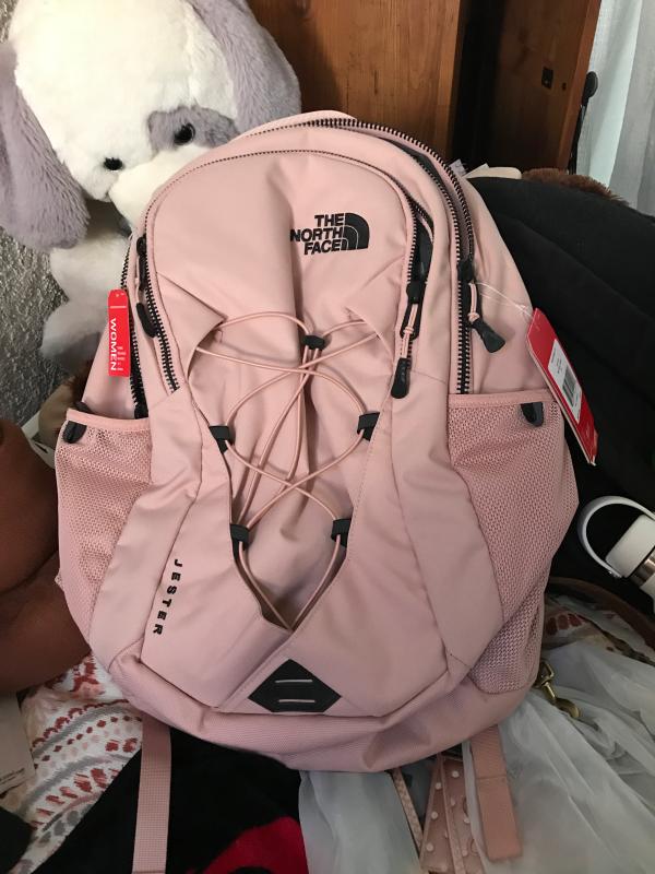 white and rose gold north face backpack