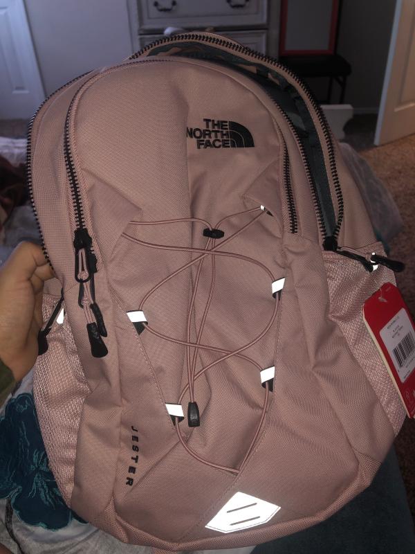 pink and white north face backpack