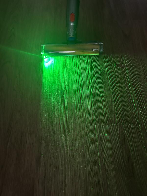 Green light showing unseen debris on floor.