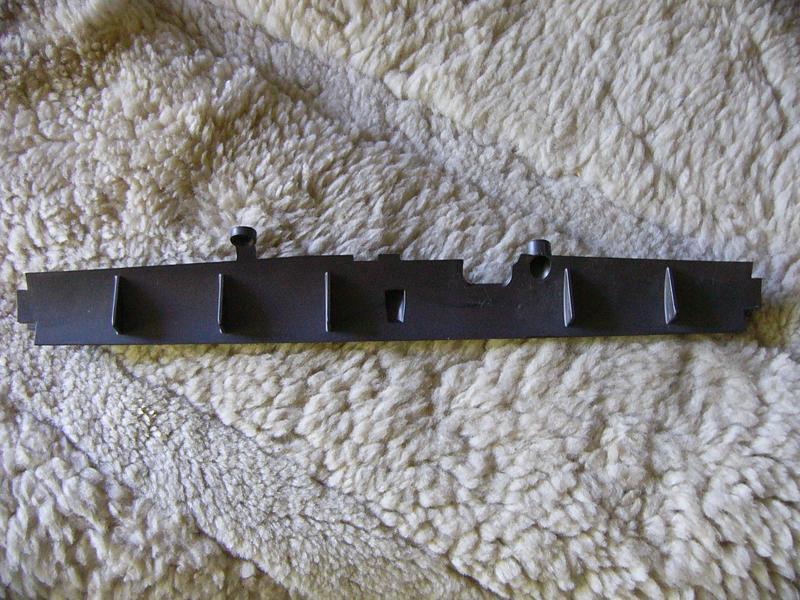 air baffle bar from brush roller head of Dyson Cinetic Ball.  Removing this greatly increases airflow and avoids jams, but may void warranty due to allowing crud into the cinetic system of the cyclone.  I took mine out, no issues so far.