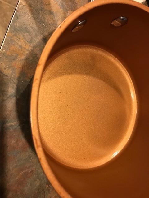 Small pot has extra coating on edge and inside