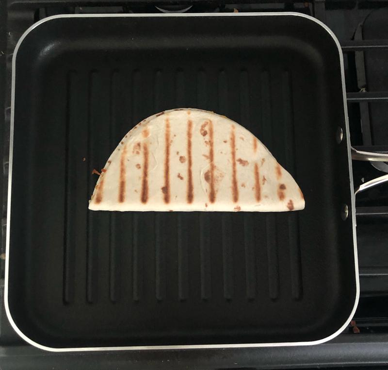 Showing on a quesadilla the perfect grilling marks.